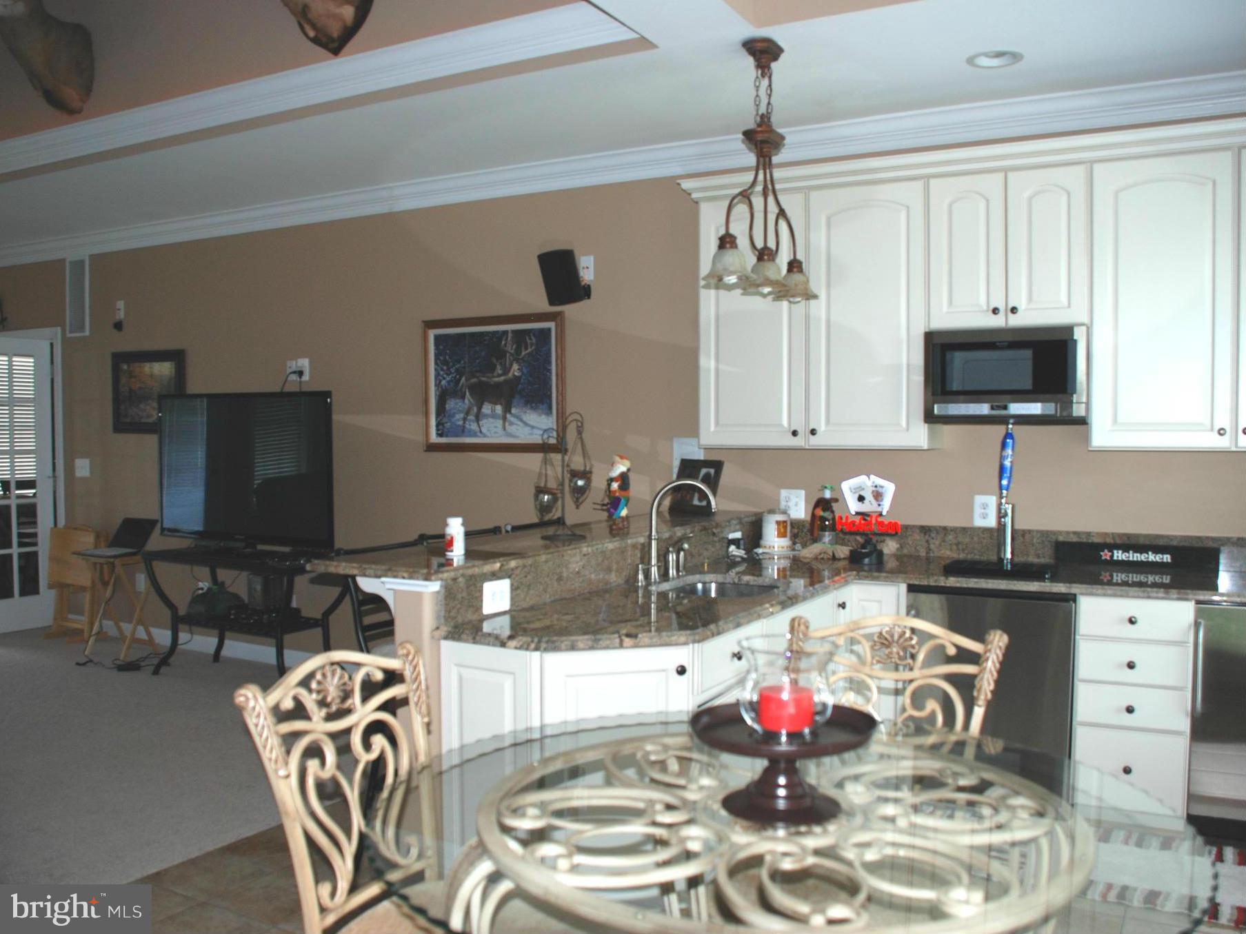6015 Boston Ridge Court Boston, VA 22713 - Photo 14 of 30 a kitchen with stainless steel appliances granite countertop a dining table and chairs with wooden floor