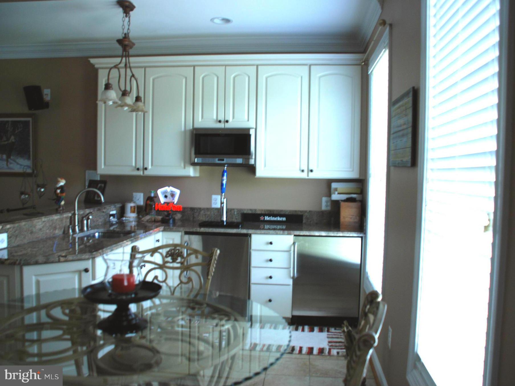 6015 Boston Ridge Court Boston, VA 22713 - Photo 15 of 30 a kitchen with a stove a sink and a microwave
