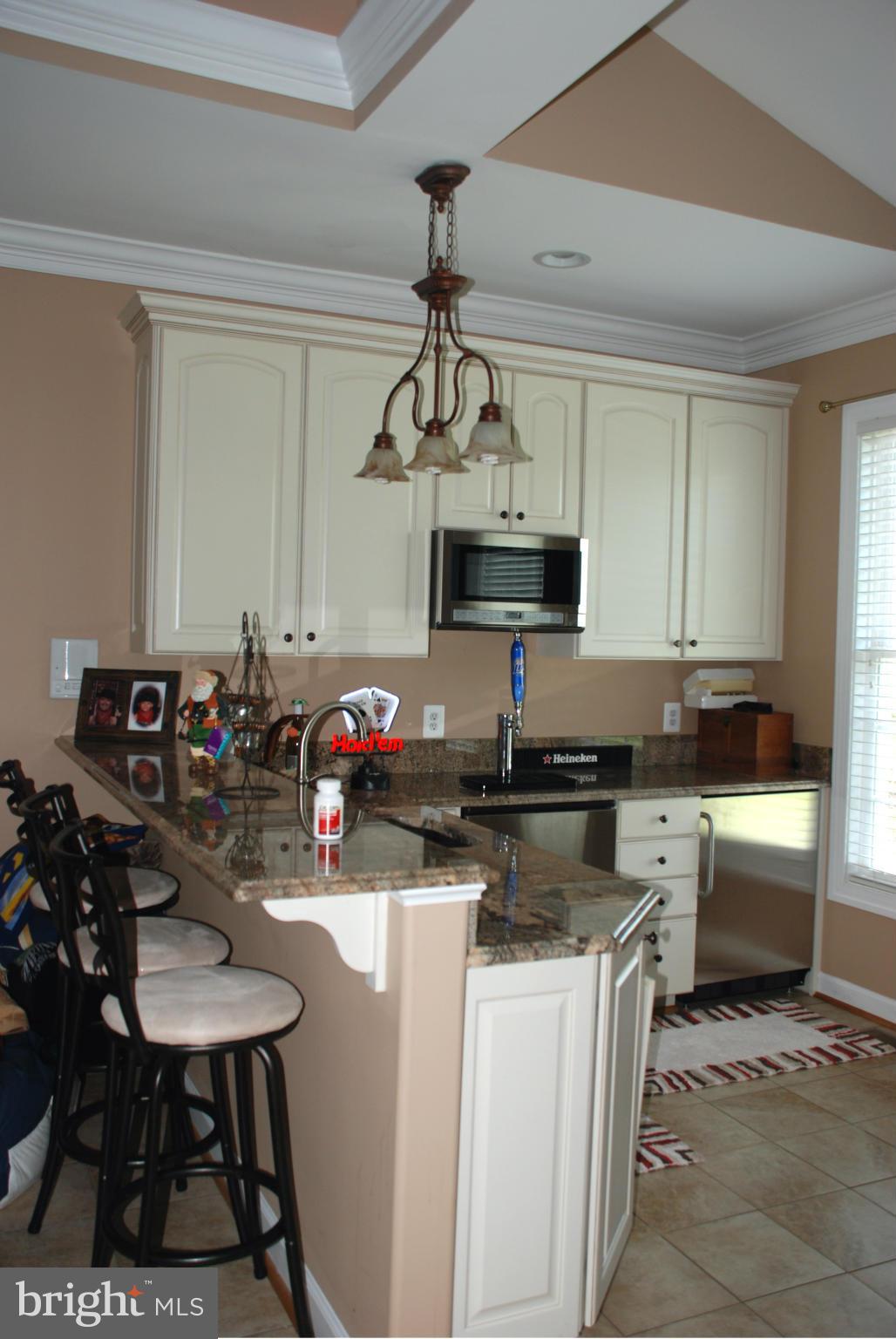 6015 Boston Ridge Court Boston, VA 22713 - Photo 16 of 30 a kitchen with a sink a stove and chairs
