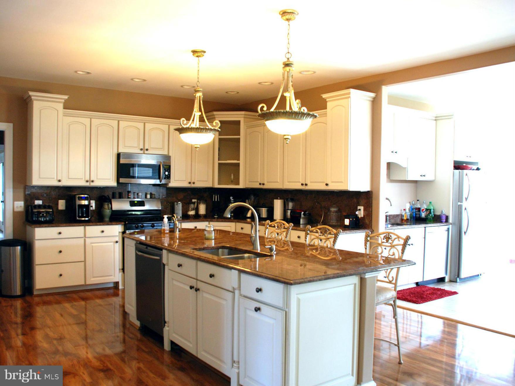 6015 Boston Ridge Court Boston, VA 22713 - Photo 6 of 30 a kitchen with stainless steel appliances granite countertop a sink a stove and white cabinets