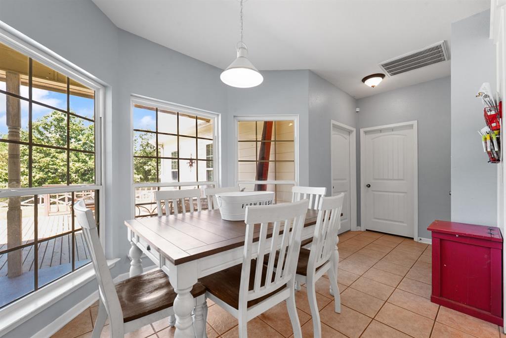 155 Rs County Road Emory, TX 75440 - Photo 13 of 31 a view of a dining room with furniture large windows and wooden floor