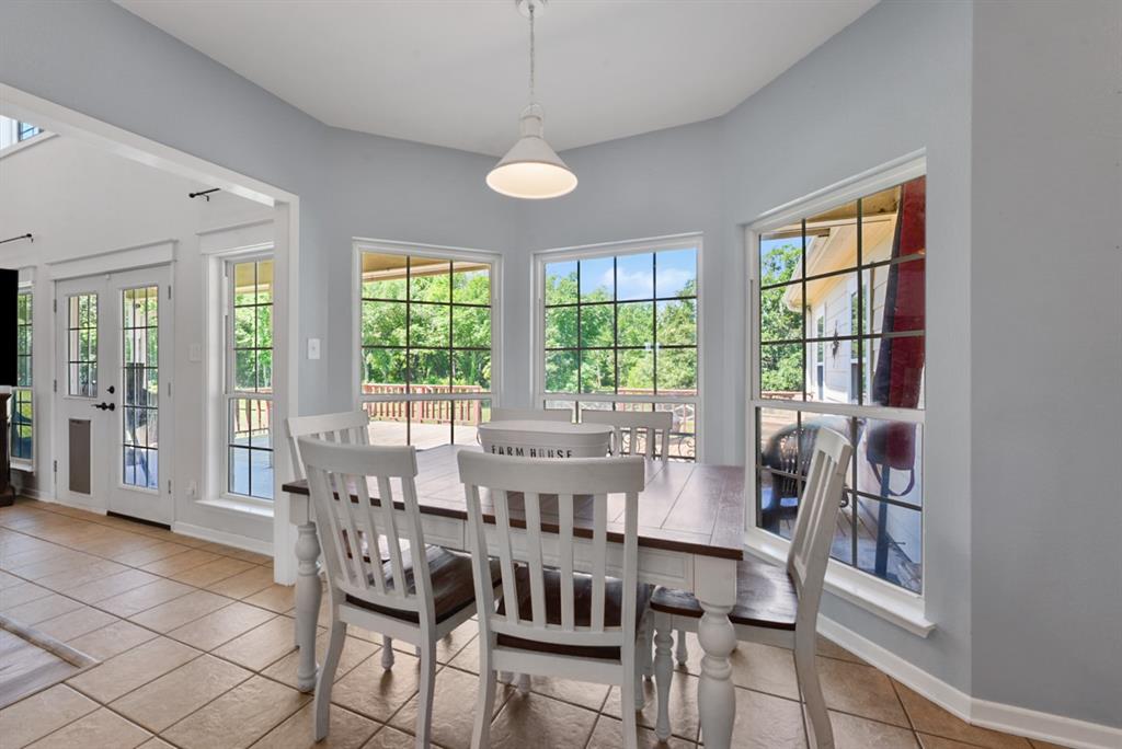 155 Rs County Road Emory, TX 75440 - Photo 14 of 31 a view of a dining room with furniture large windows and wooden floor