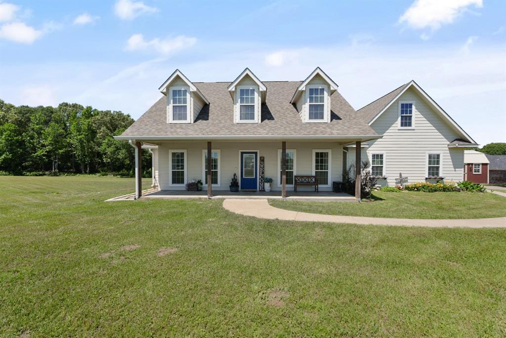 155 Rs County Road Emory, TX 75440 - Photo 2 of 31 a front view of a house with a garden