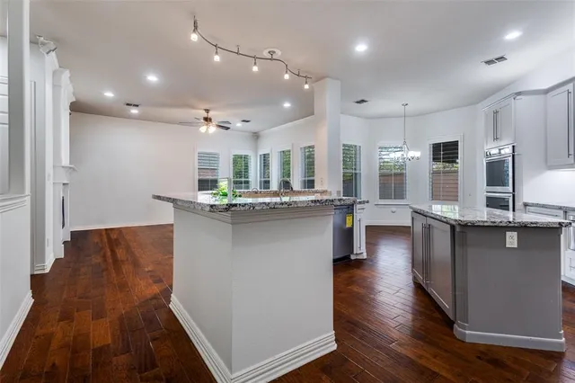 a view of a kitchen with a sink and a stove top oven