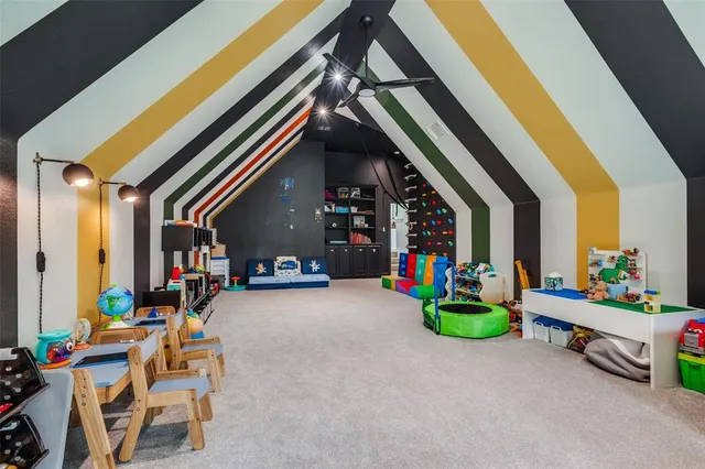 a view of play room with chairs and toys