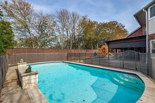 a view of swimming pool with outdoor seating and plants