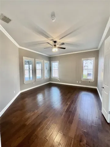 a view of wooden floor and windows in a room