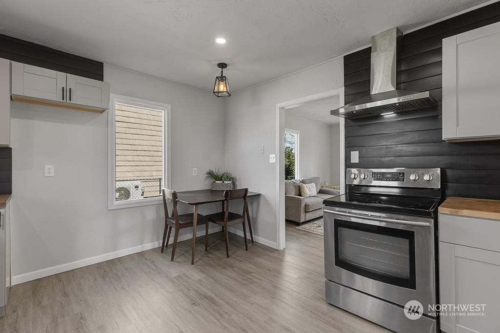 908 West Chestnut Street Walla Walla, WA 99362 - Photo 6 of 23 a kitchen with a stove and a wooden floor