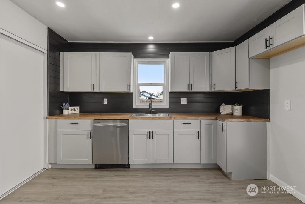 908 West Chestnut Street Walla Walla, WA 99362 - Photo 7 of 23 a kitchen with stainless steel appliances granite countertop a stove a sink and white cabinets