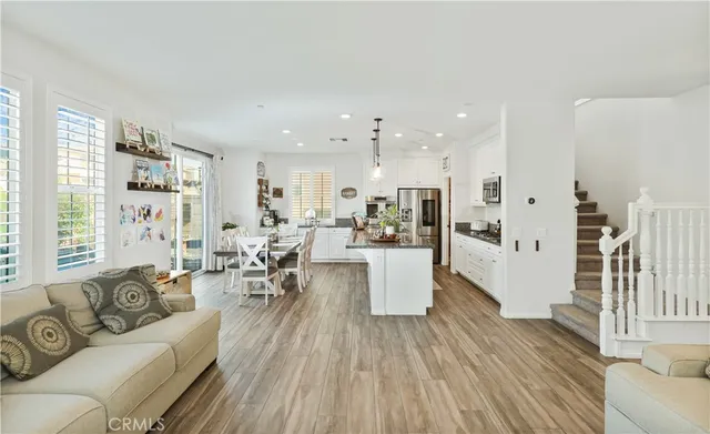 a living room with furniture and view of kitchen