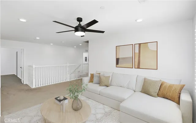 an empty room with windows and ceiling fan