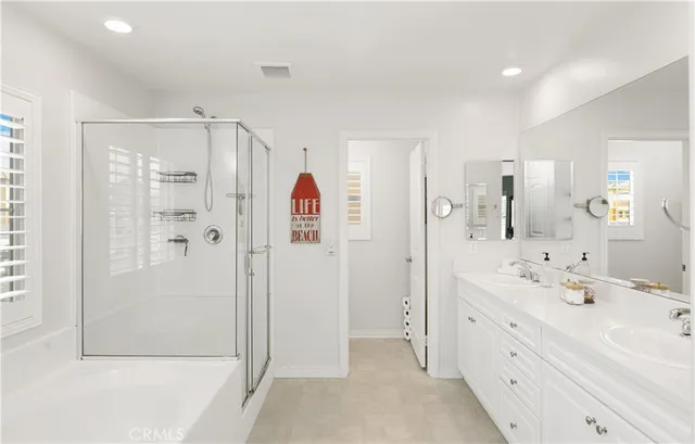 a bedroom with bed tv and a window