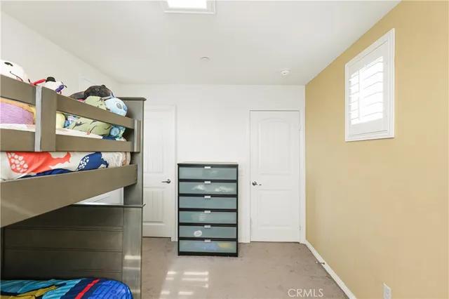 a patio with glass top table and chairs