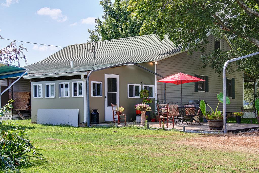 3920 Corbin Sneed Road Springfield, TN 37172 - Photo 3 of 29 a patio with a table and chairs under an umbrella