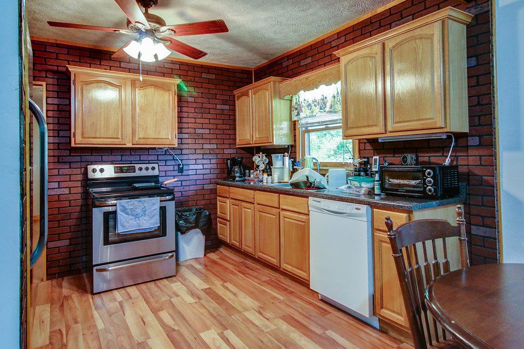 3920 Corbin Sneed Road Springfield, TN 37172 - Photo 8 of 29 a kitchen with stainless steel appliances granite countertop a stove a sink and a microwave