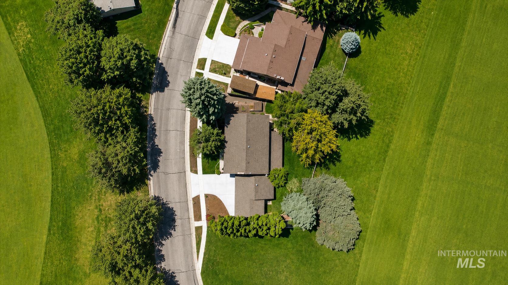 599 Pebble Beach Way Eagle, ID 83616 - Photo 38 of 44 Aerial perspective showcasing residential properties with brown shingle roofs