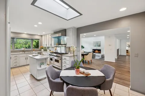 a living room with furniture kitchen and a table