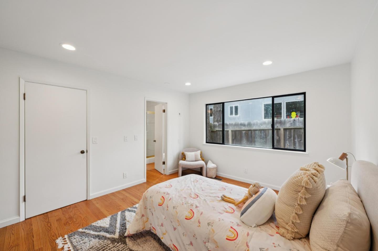 4083 Sunset Lane Pebble Beach, CA 93953 - Photo 46 of 54 a bedroom with a bed and wooden floor