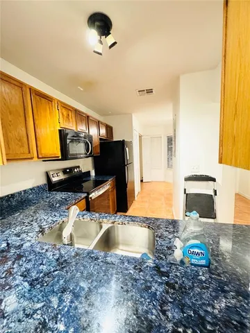 a kitchen with a sink a stove and a microwave