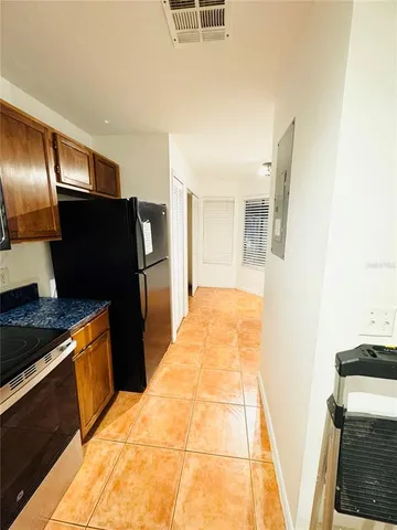 a kitchen with stainless steel appliances granite countertop a refrigerator and a stove