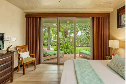 a bedroom with a bed and large window