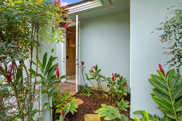 a front view of a house with outdoor seating and plants