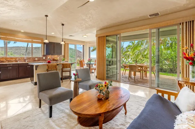 a kitchen with a large window and dining table