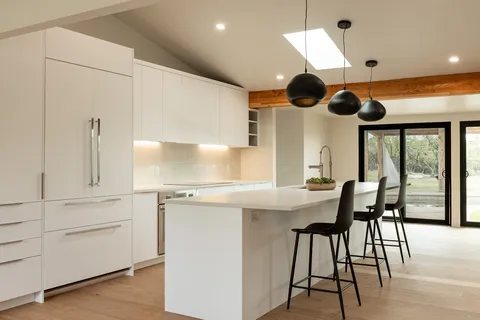 a kitchen with a table chairs and a window