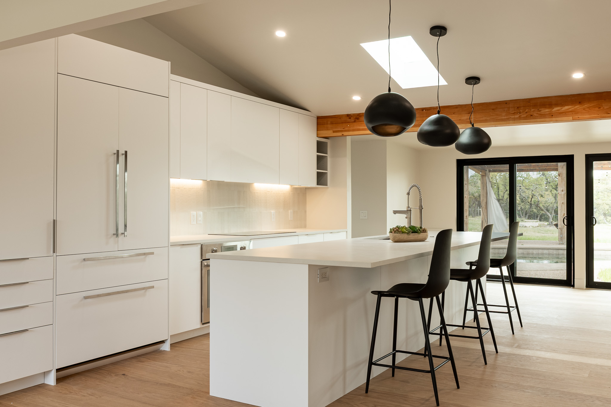 a kitchen with a table chairs and a window