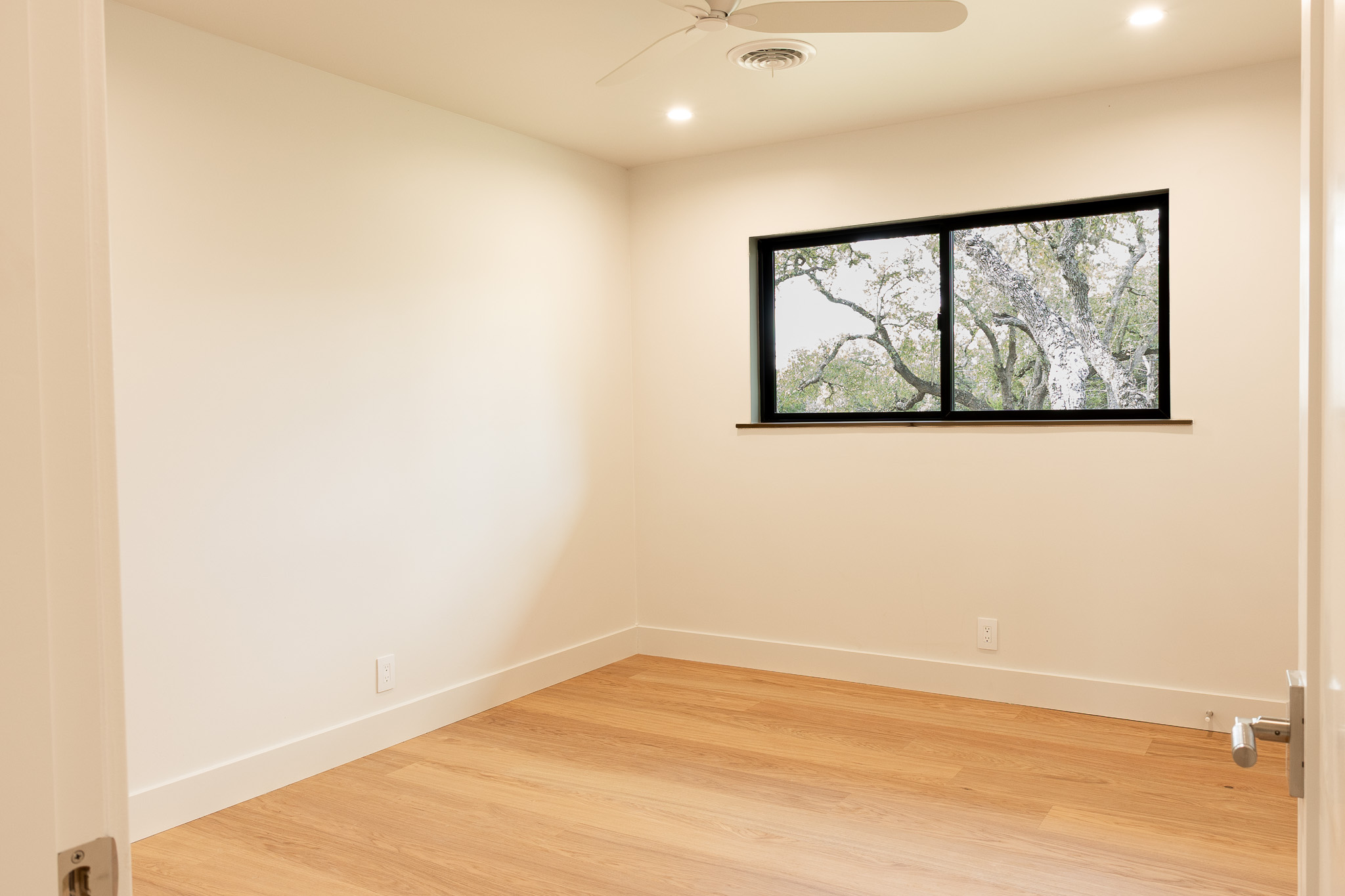 8717 South View Road Austin, TX 78737 - Photo 18 of 36 a view of wall with window and painting on the wall