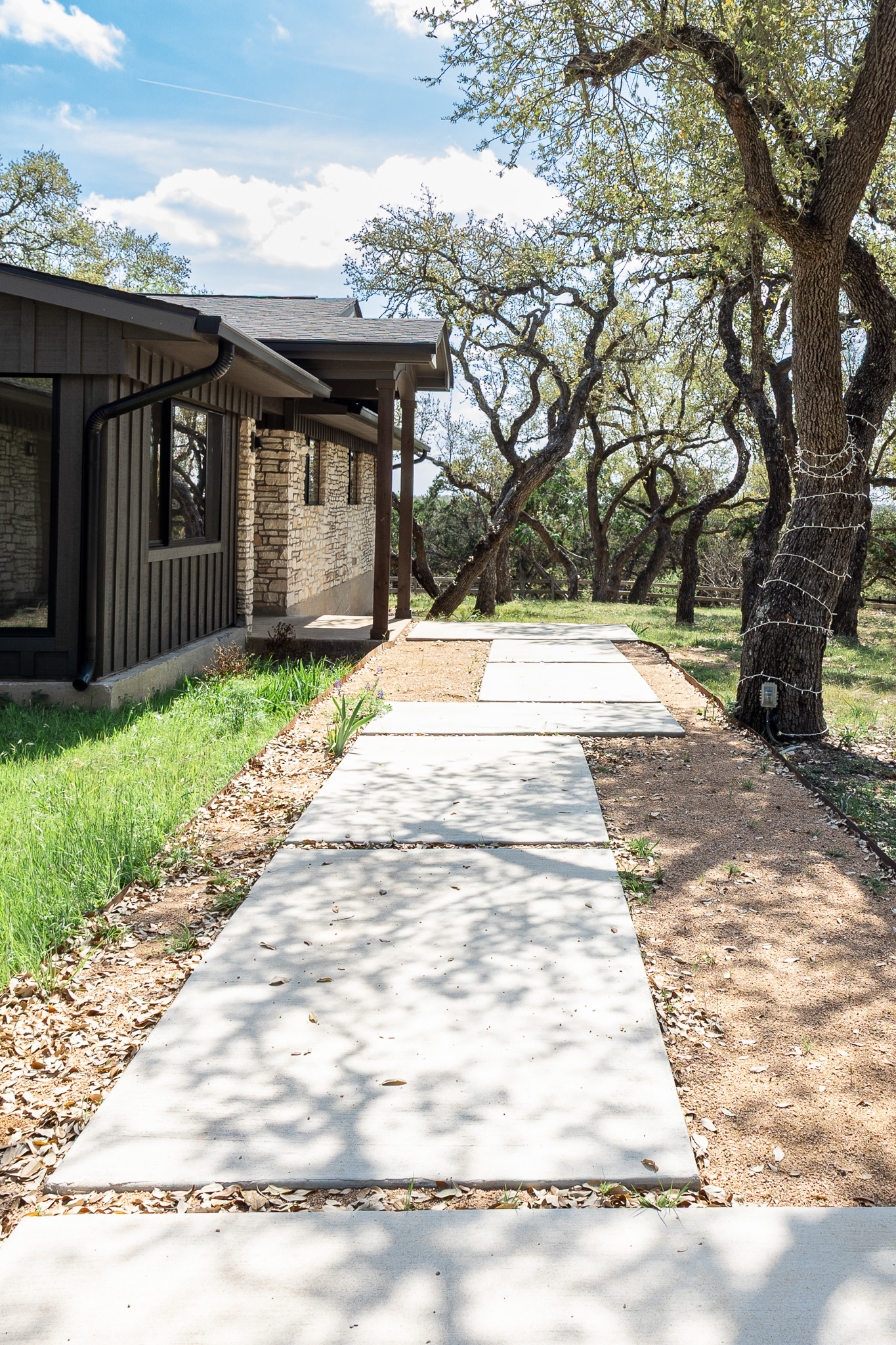 8717 South View Road Austin, TX 78737 - Photo 2 of 36 a front view of a house with a yard