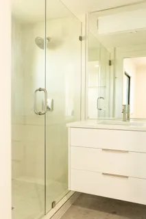 a bathroom with a shower and a sink