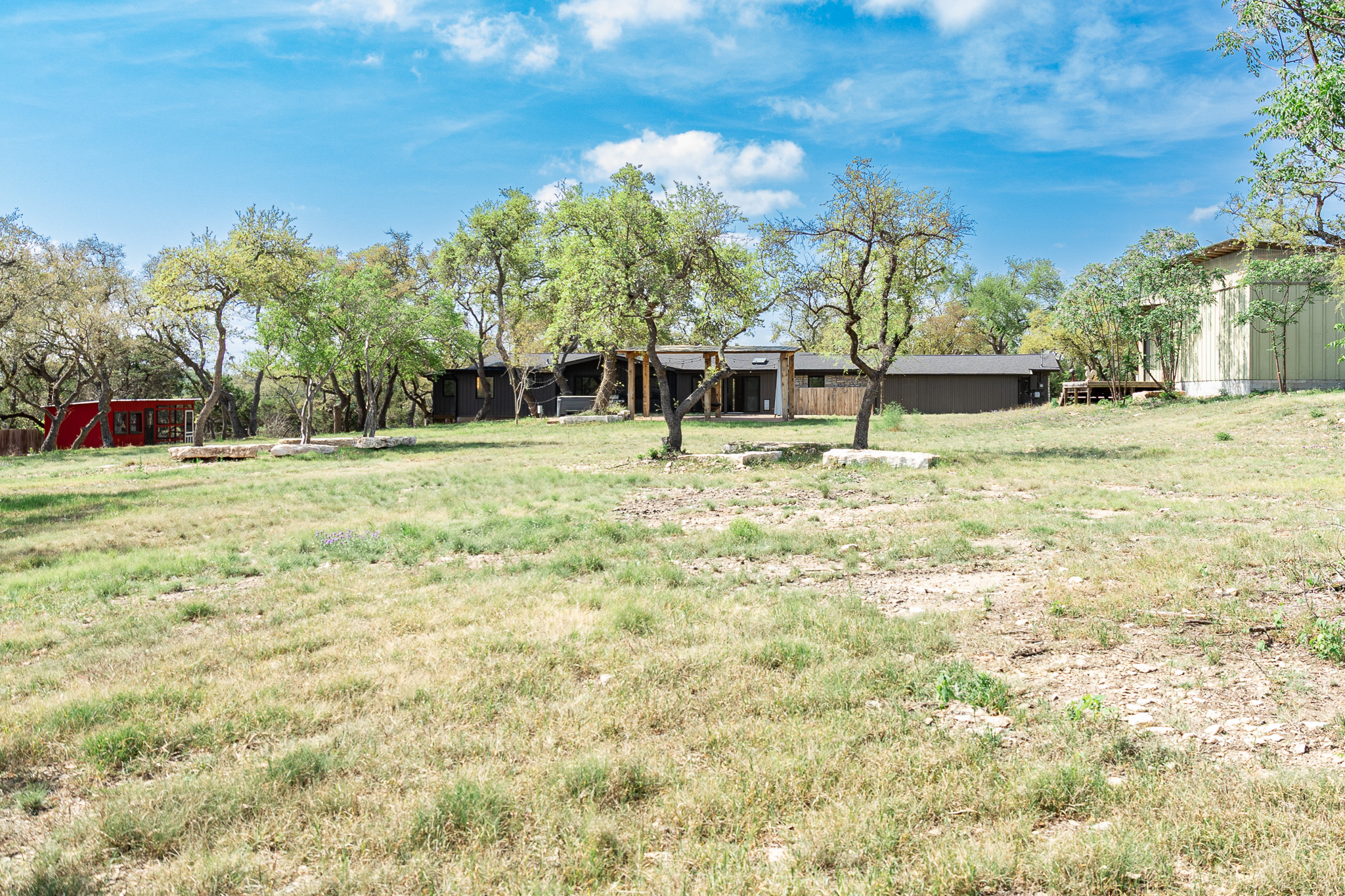 8717 South View Road Austin, TX 78737 - Photo 33 of 36 a backyard of a house with lots of green space and tree