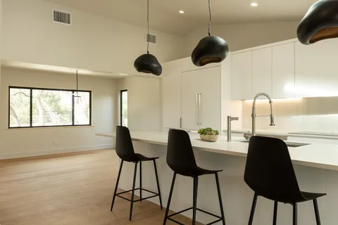 a view of a room with a window and furniture