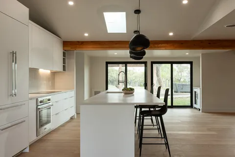 a kitchen with a table chairs and a stove