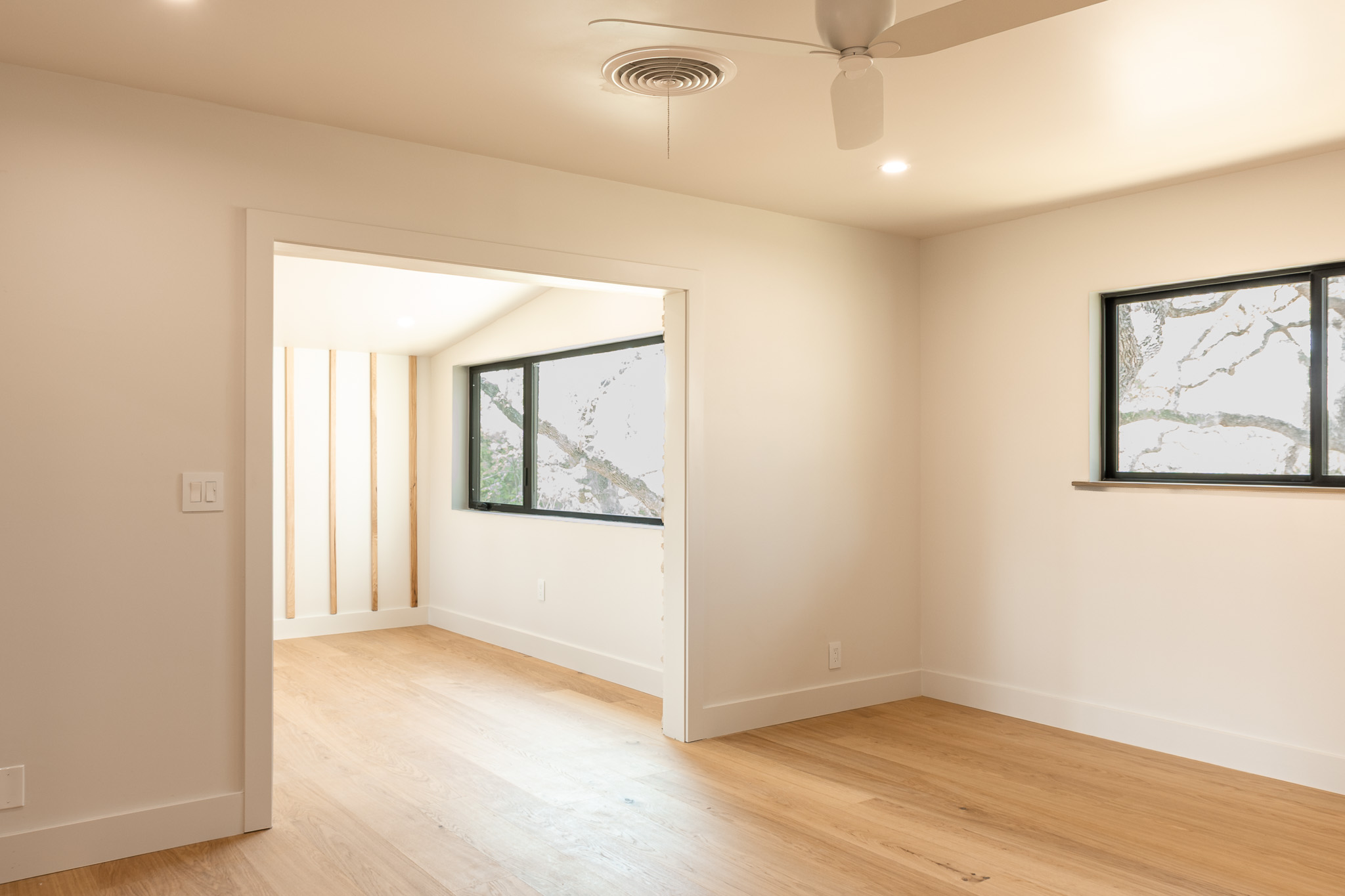 8717 South View Road Austin, TX 78737 - Photo 10 of 36 a view of an empty room with wooden floor and a window