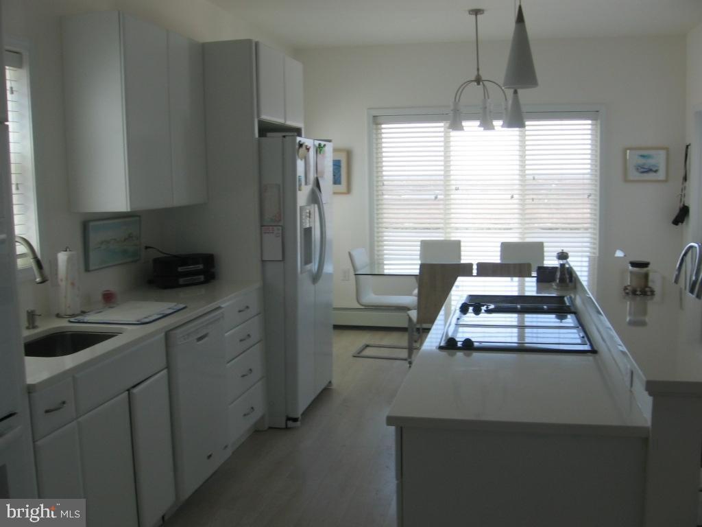 1603 Mill Creek Road Manahawkin, NJ 08050 - Photo 4 of 13 a kitchen with appliances a window and cabinets