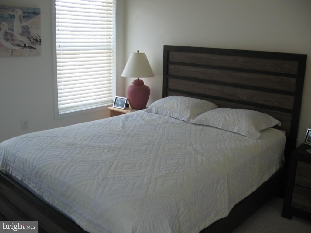 1603 Mill Creek Road Manahawkin, NJ 08050 - Photo 8 of 13 a bed sitting in a bedroom next to a window