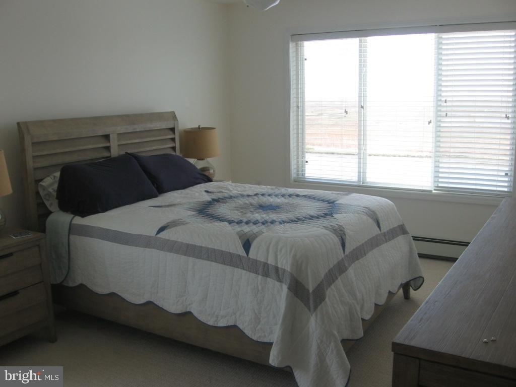 1603 Mill Creek Road Manahawkin, NJ 08050 - Photo 10 of 13 a bed sitting in a bedroom next to a window
