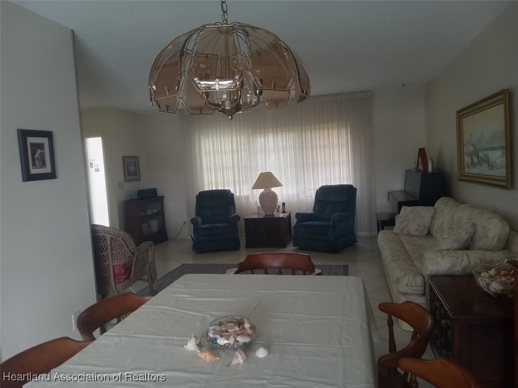 756 Coventry Street Boca Raton, FL 33487 - Photo 7 of 23 a living room with furniture a chandelier a rug and a window