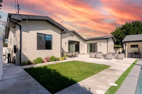 a view of outdoor sitting area with furniture and wooden floor