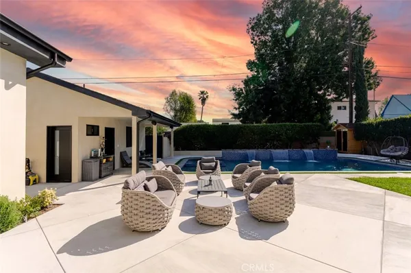 a view of a backyard with swimming pool