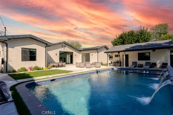 a view of a patio with swimming pool table and chairs