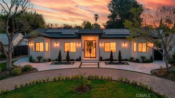 a view of a brick house with a small yard