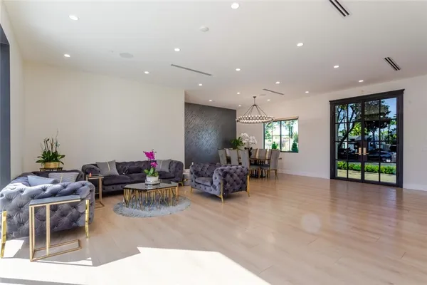 a large kitchen with stainless steel appliances granite countertop a refrigerator a sink dishwasher a stove and a refrigerator