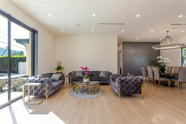 a kitchen with stainless steel appliances granite countertop a sink a stove and a wooden floors