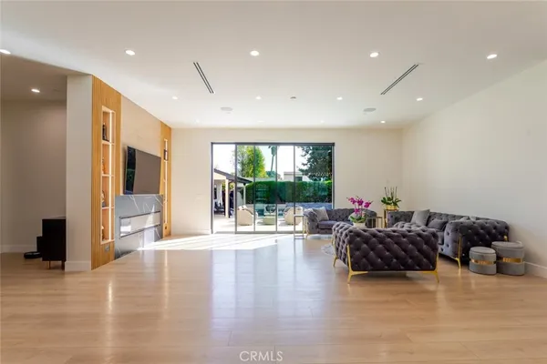 a kitchen with stainless steel appliances granite countertop a sink a stove and a refrigerator