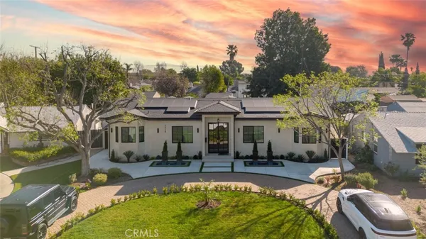 a view of a house with swimming pool and sitting area
