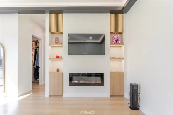 a living room with furniture a flat screen tv and a large window