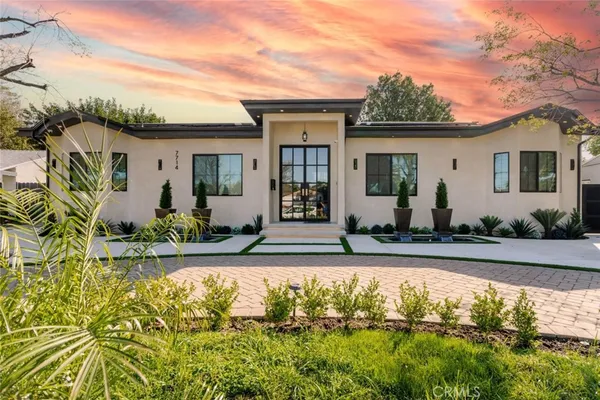 a house with swimming pool in front of it